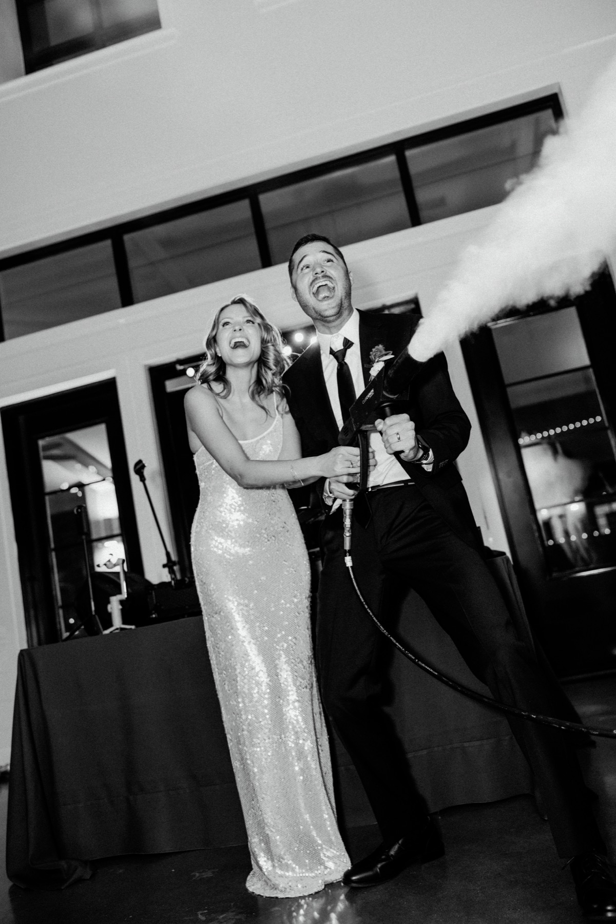 Newlyweds laughing together at their reception